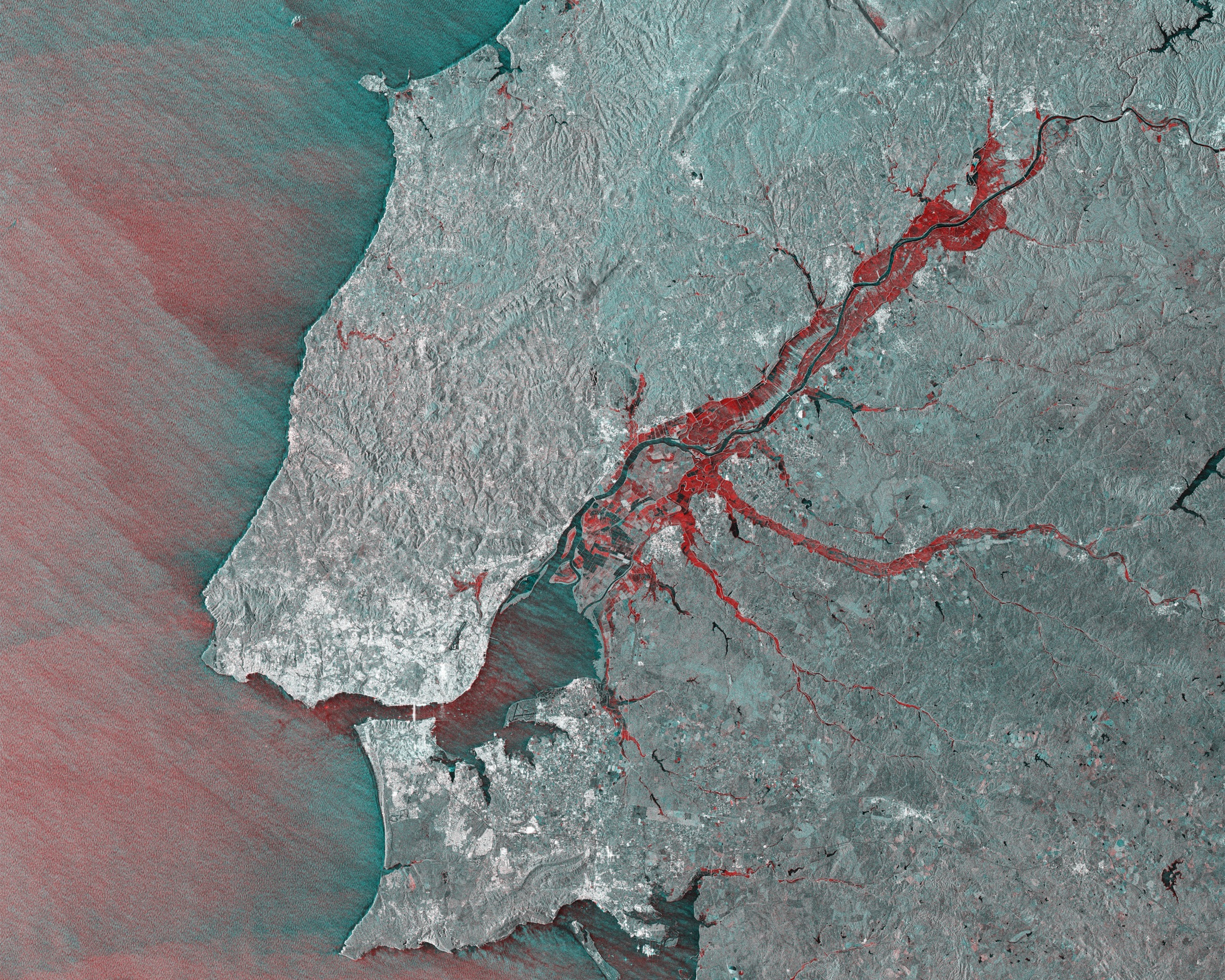 Flooding around the Tejo River, Portugal, in a Copernicus Sentinel-1 radar change-detection composite of 27 December 2025 and 7 February 2026 acquisitions; areas in red show where flood water rose after storms Kristin, Leonardo and Marta. Contains modified Copernicus Sentinel data (2025-26), processed by ESA.